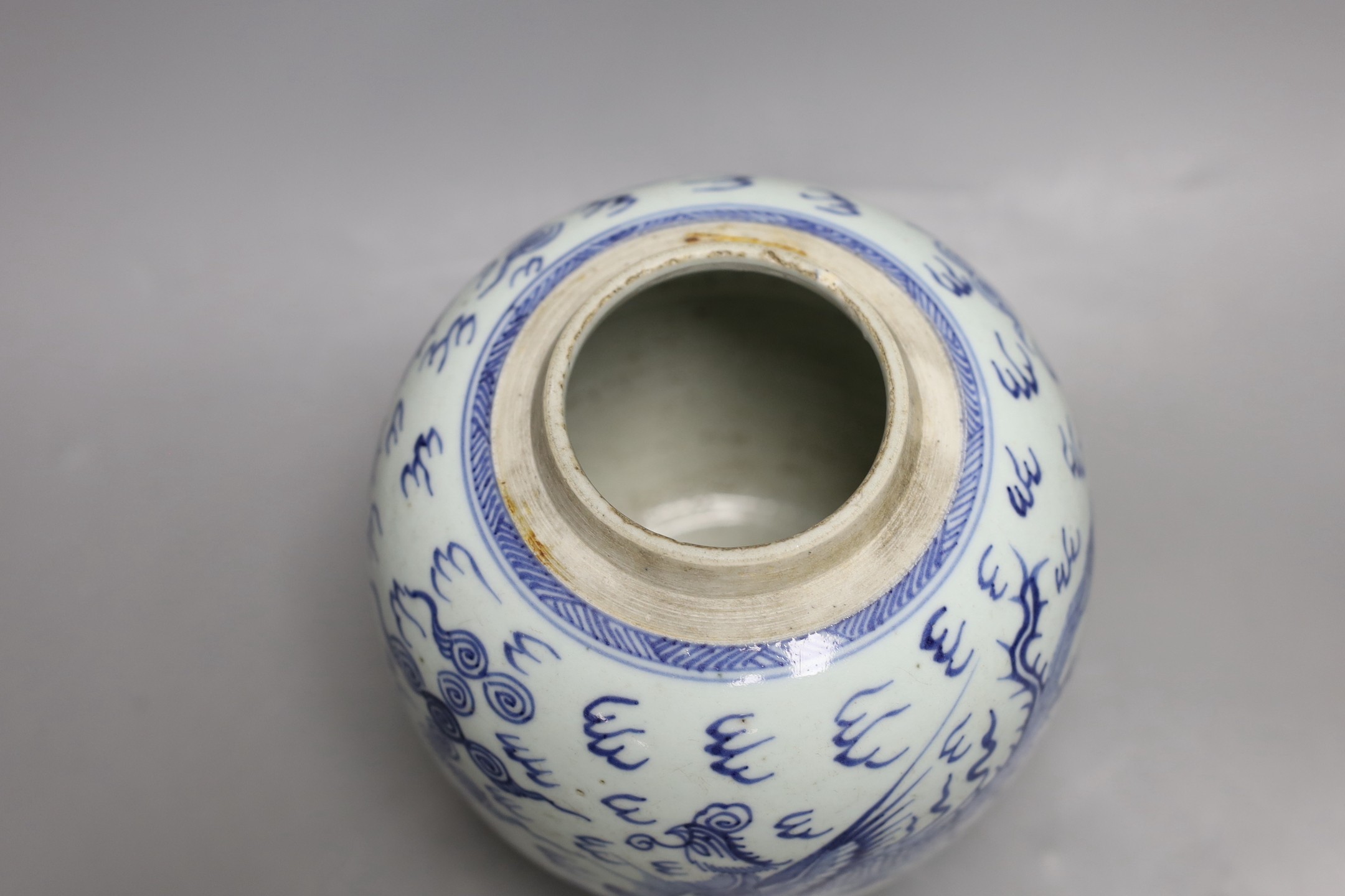An 18th century Chinese provincial blue and white dragon and phoenix jar, 20cm high